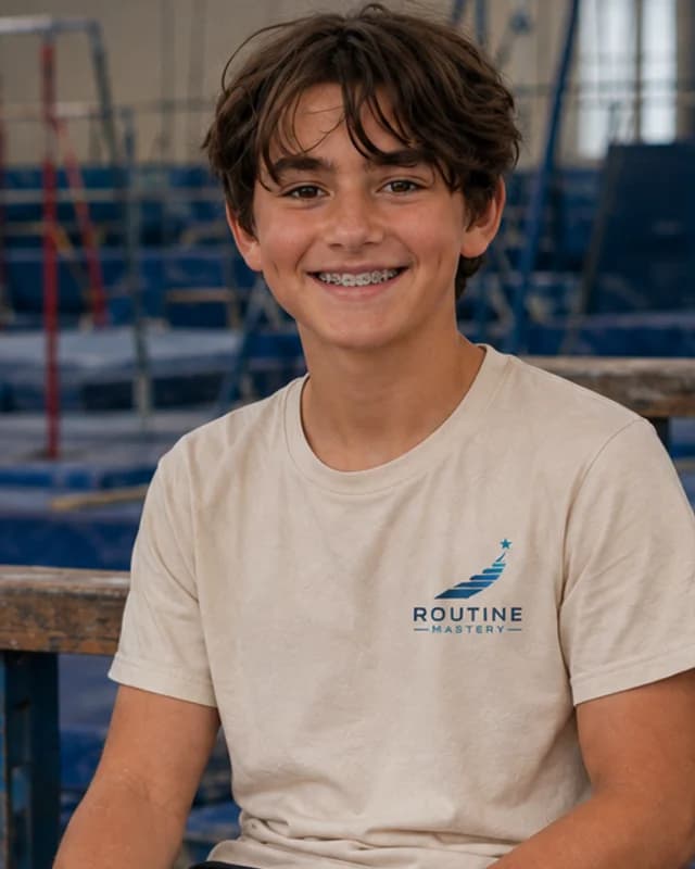 Jaxon, seated on the gym bleachers holding a notebook